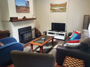 Lounge room with TV, DVD player, woodfired heater