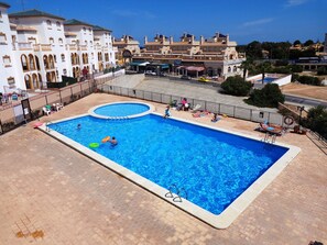 Communal heated pool as viewed from 2nd floor. Shops/bars close in background.