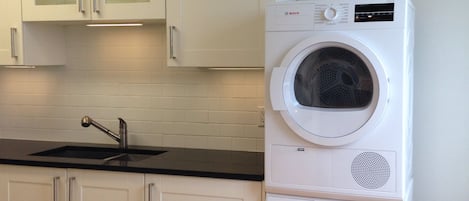 Newly renovated kitchen with in-suite laundry facility and dish washer