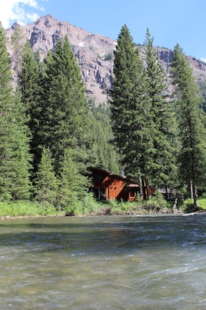 View of the cabin from Soda Butte Creek, with Mount Republic in the background