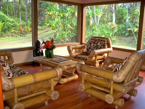 Enjoy the sights and smells of the rainforest from the screened-in living room