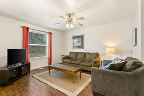 Relaxing and comfortable living room with fold out couch for extra heads on pillows.