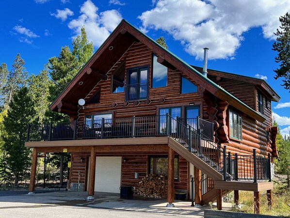 Log cabin on 3 acres with large paved driveway, deck and picnic area.