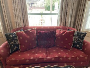 Antique sofa in Ebony Rouge with beautiful view out the bay window.