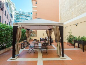 Plant, Table, Building, Furniture, Outdoor Table, Chair, Shade, Outdoor Furniture, Tent, Sky