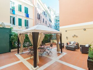 Plant, Table, Building, Window, Outdoor Table, Shade, Outdoor Furniture, Flowerpot, Flooring, Chair