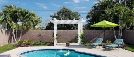 Beautiful backyard oasis with lush, tropical plants.