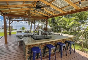 Outdoor kitchen and lakefront pergola