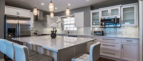 Kitchen view with a lovely aisle for dining. 