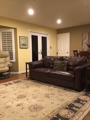 Family room including french doors that open to side deck and BBQ sitting area.