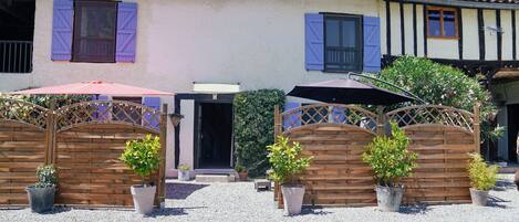 Front entrance to the gite with an outdoor seating area and the jacuzzi.