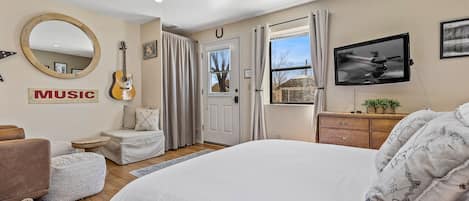 *NEW Queen bed looking on to the living area.