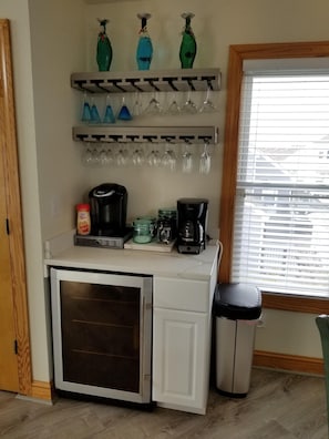 Beverage & coffee bar holds wine bottles as well as water & canned drink