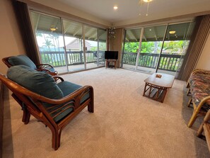 Living room with two large sliding doors that open to wrap around lanai