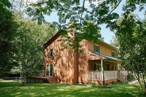 Side view of the Farm House with front porch and back deck