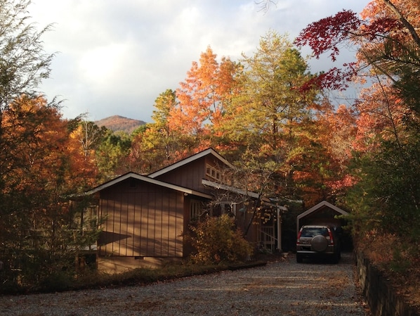 Cabin fall view with large flat parking area.