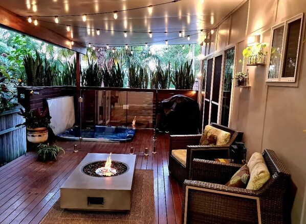 Private outdoor area with heated spa and fire table 