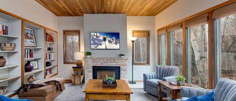 Spacious living area with cable television, gas fireplace and oversize windows