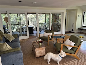 Living room opens onto screened porch.