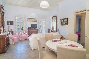 The generous living room with open plan kitchen and large dinner table