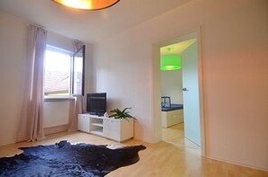 Living and sleeping room connected with a satin glas door.  