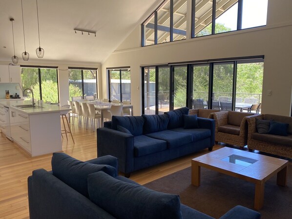 Family room with sofas and arm chairs to seat 10