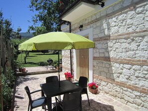 Private entrance to the apartment. Outdoor dining overlooking the garden.