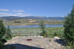 Summer view with fire pit and lake.