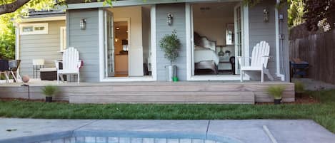 The view from the pool to the private back deck and french doors.