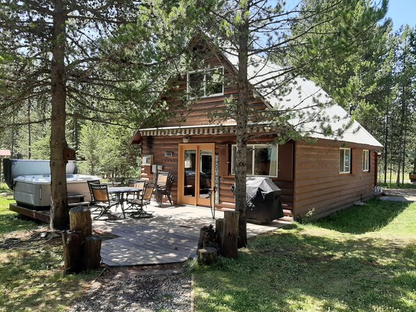 Back deck with hot tub(year round), patio set and grill.