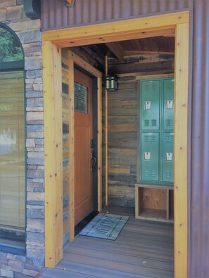 Covered front entry with lockers and rack to hang skis