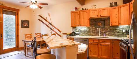 Newly updated kitchen features granite counters & backsplash & new appliances.