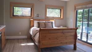 Lower Master Suite showing queen bed and large sliding window