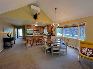 Dining area with round table and barstool seating