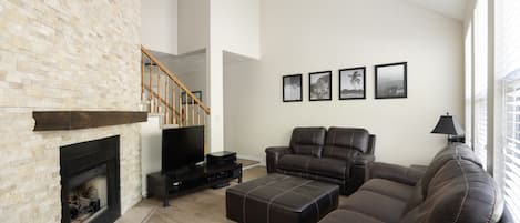 Living room with 65" HDTV with surround sound and DVD player