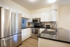 Newly remodeled kitchen with stainless steel appliances and granite counter tops