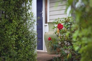 Wander through the lush green hedge and there lies this charming hideaway...