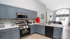 Updated kitchen with modern appliances, open to family room