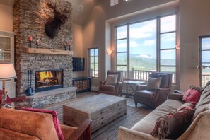 Large open living room w/ wood burning fireplace, plenty of seating & best views