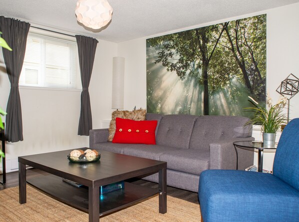 Living room with new triple seater couch and chair