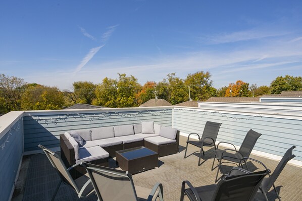 Large rooftop deck with plenty of seating.