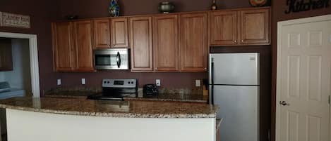 Kitchen with granite counter tops, oak cabinets and stainless steel appliances