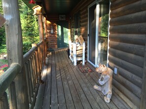 Front porch with firewood stack and sliding door from great room.