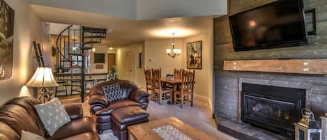 Open concept living/dining area with flat screen TV and fireplace