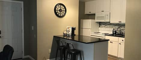 Newly remodeled kitchen complete with granite counter top and tile back splash.