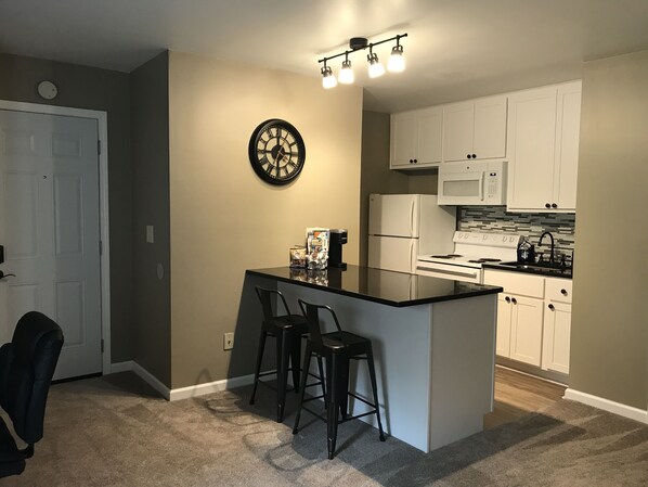 Newly remodeled kitchen complete with granite counter top and tile back splash.