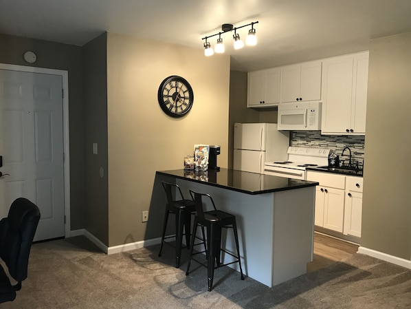 Newly remodeled kitchen complete with granite counter top and tile back splash.