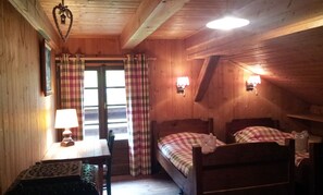 Chambre avec 2 lits savoyards et un grand lit. Balcon orienté sud.