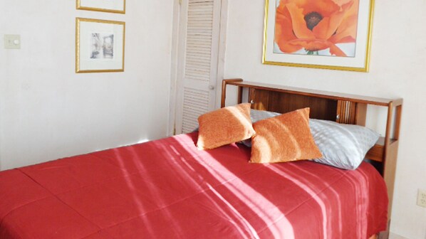 Bedroom with mid-century head board and Georgia O'Keeffe print above