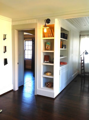 bookcase area with guest book and quill feather pen